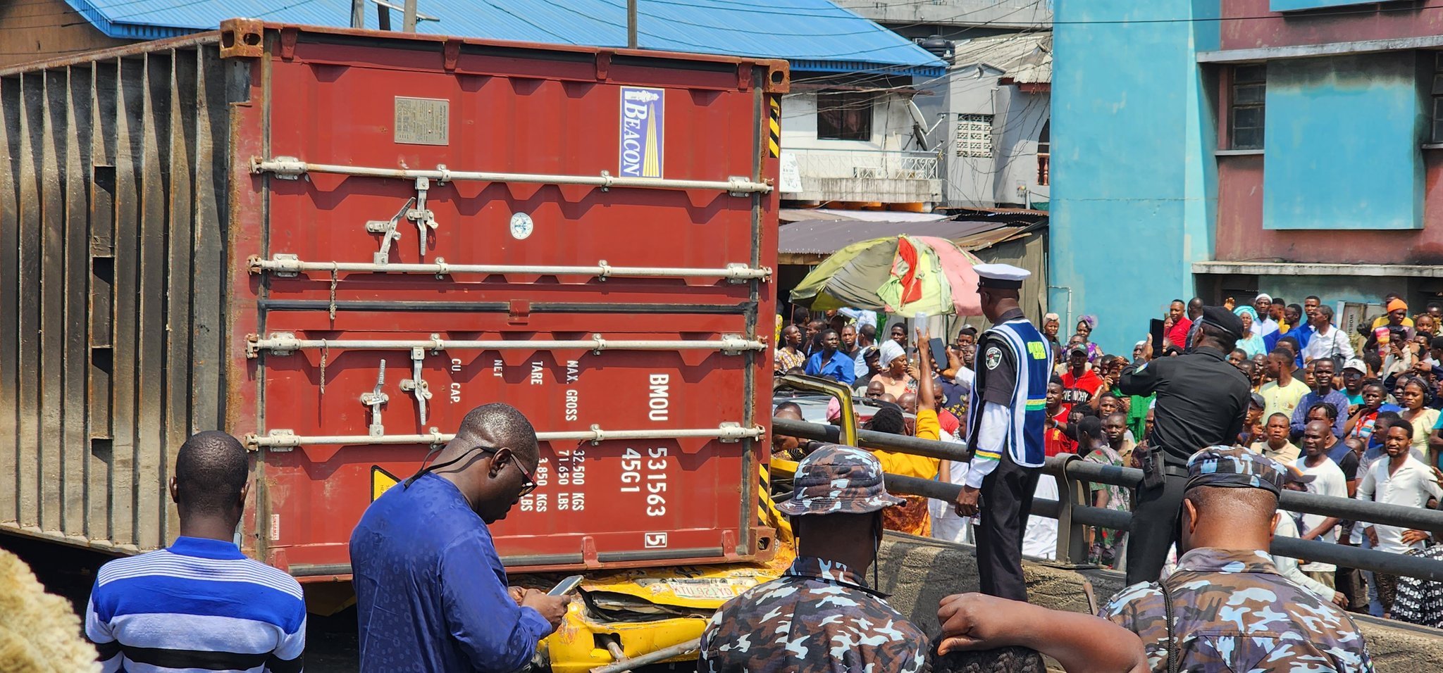 Breaking: Container Falls On A Bus At Ojuelegba Bridge Passengers Trapped.